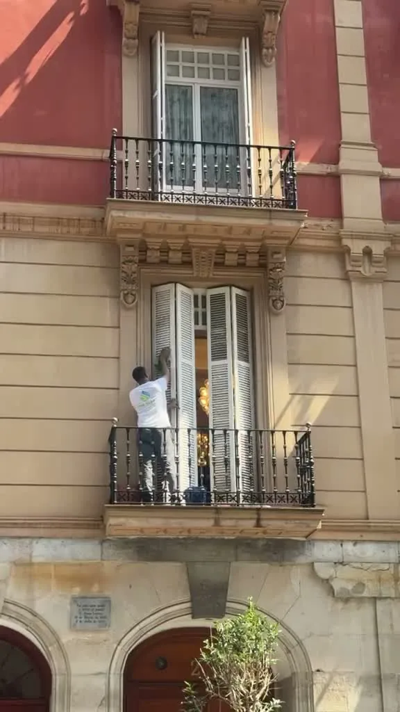 Operario de Ipar Clean limpiando las ventanas de un edificio de viviendas en Bilbao